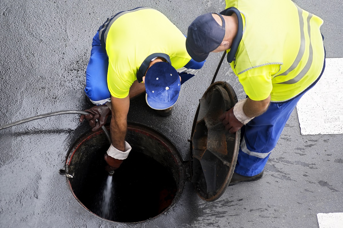 Workers cleaning the sewer